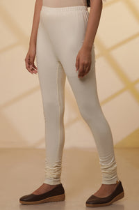 Cream Solid Plain Skinny Cotton Churidar