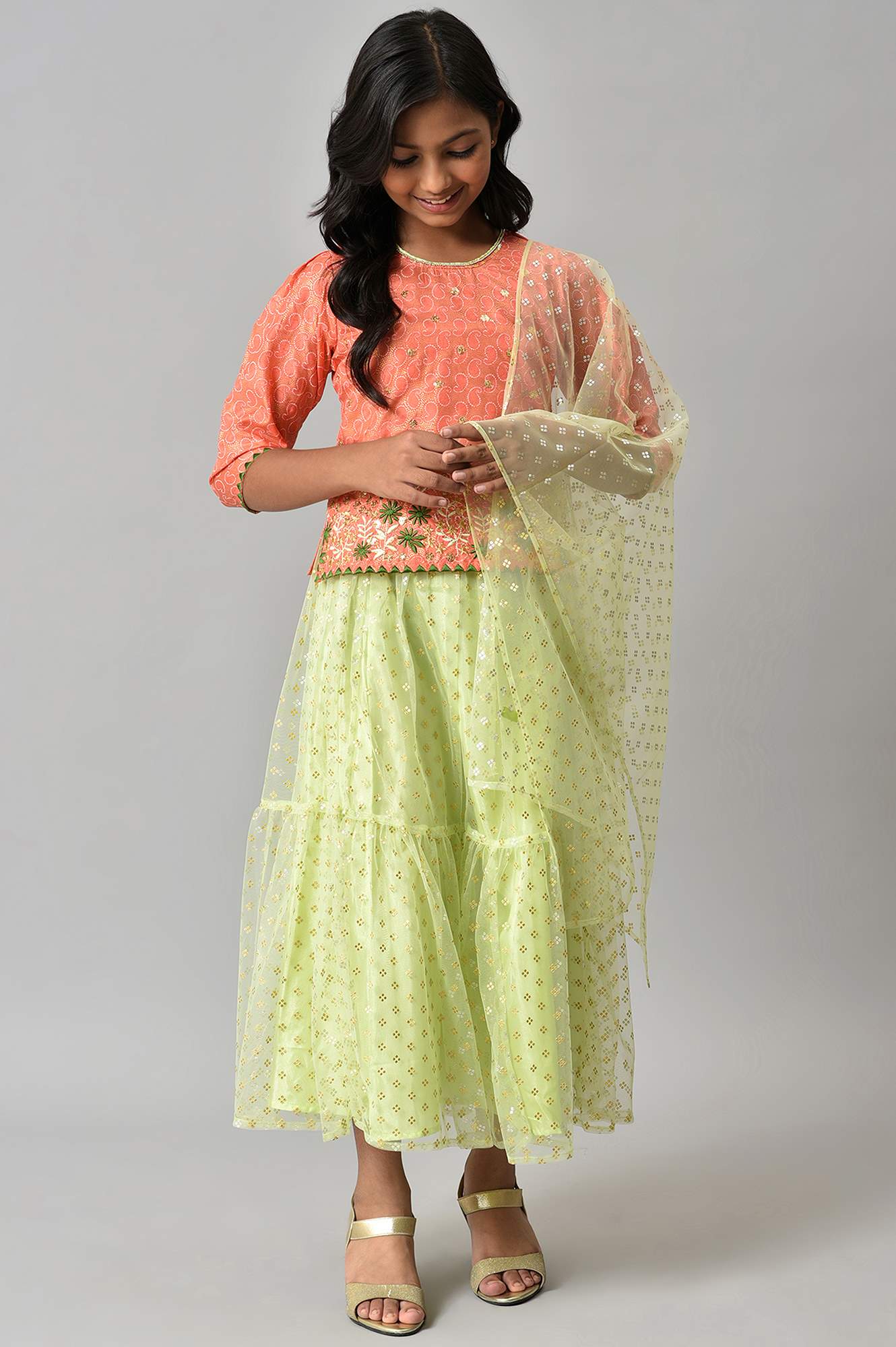 Girls Orange Foil Printed Top With Green Flared Skirt And Dupatta